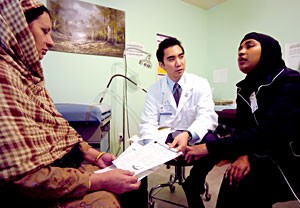 Patient Recruitment Challenges - A medical interpreter facilitates conversation between a patient and a doctor