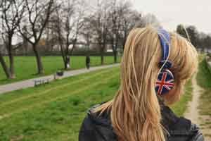 Multilingual SEO - Girl Listening to Headphones with Union Jack