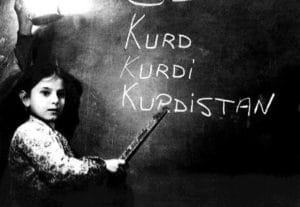 a girl pointing at the word "Kurdistan"