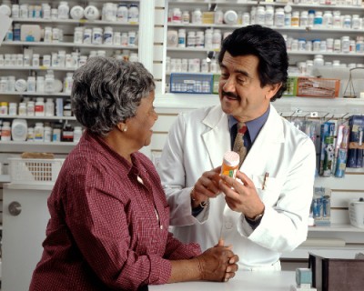 Prescription Translation Services - Pharmacist Helping Woman With Drug Label