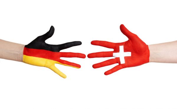 swiss german flags on hands