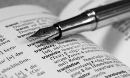 Linguistic Review - Pen Placed on Dictionary