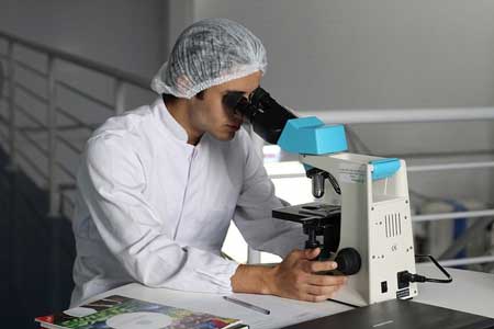 EU Update Medical Device Translation - Person Looking Through Microscope